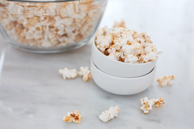 Spicy Popcorn | BourbonandHoney.com -- Spicy, salty and totally snackable. This Spicy Popcorn is a delicious twist on a classic snack.