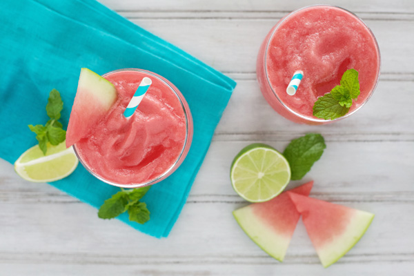 Watermelon Tequila Slush | BourbonandHoney.com -- This frosty, boozy and pretty pink Watermelon Tequila Slush cocktail is a tasty and refreshing way to keep you cool all summer long.