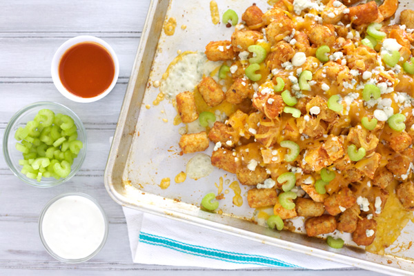 Buffalo Chicken Tater Tot Nachos | BourbonAndHoney.com -- These delicious Tater Tot Nachos are cheesy, bacon-y and delicious! They're the perfect appetizer for a party!