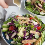 Avocado and Chicken Tortilla Salad | BourbonandHoney.com -- This Avocado and Chicken Tortilla Salad is piled with avocado, spicy jalapeño, crunchy tortilla strips and a bright lime dressing for a hearty weeknight salad.