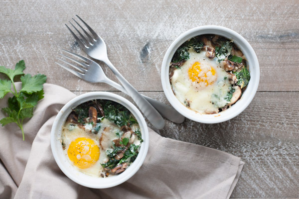 Baked Eggs with Kale and Mushrooms | BourbonandHoney.com -- These creamy, indulgent Baked Eggs with Kale and Mushrooms are perfect for a lazy weekend breakfast. 