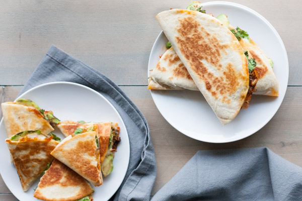 Kimchi Quesadilla | BourbonandHoney.com -- These over-the-top cheesy Kimchi Quesadillas are a deliciously greasy and spicy snack or cocktail party appetizer.