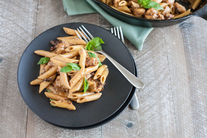 Penne with Chicken and Sun Dried Tomatoes | BourbonandHoney.com -- This Penne with Chicken dish takes dinner to the next level with a bit of cheese, sun dried tomato and some pasta for a quick weeknight meal.