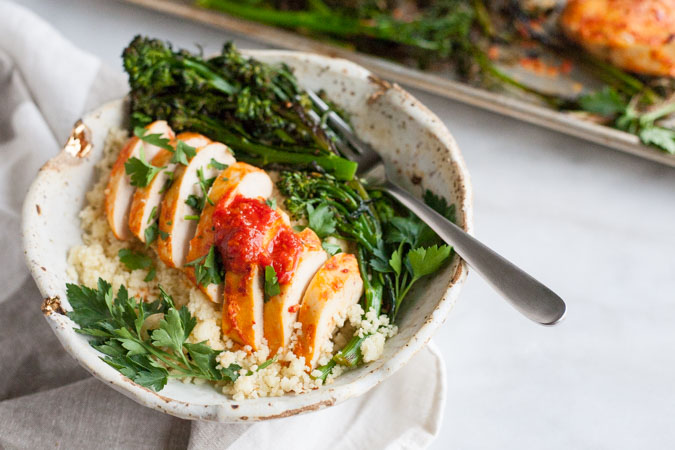 Roasted Harissa Chicken with Broccolini and Couscous | BourbonandHoney.com -- This Spicy Roasted Harissa Chicken is a super easy sheet pan supper, it's paired with broccolini and couscous and ready in about 30 minutes!