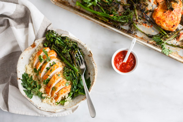 Roasted Harissa Chicken with Broccolini and Couscous | BourbonandHoney.com -- This Spicy Roasted Harissa Chicken is a super easy sheet pan supper, it's paired with broccolini and couscous and ready in about 30 minutes!