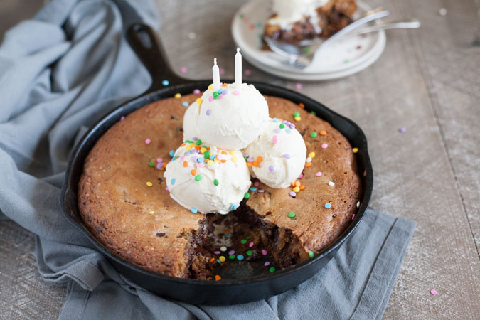 Bourbon and Honey Brown Butter Chocolate Chunk Skillet Cookie | BourbonandHoney.com -- This over-the-top Brown Butter Chocolate Chunk Skillet Cookie is spiked with Bourbon and Honey and perfect for celebrating!