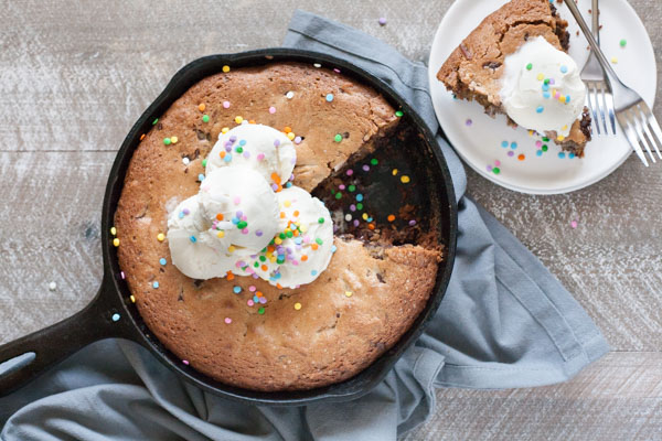 Bourbon and Honey Brown Butter Chocolate Chunk Skillet Cookie | BourbonandHoney.com -- This over-the-top Brown Butter Chocolate Chunk Skillet Cookie is spiked with Bourbon and Honey and perfect for celebrating!