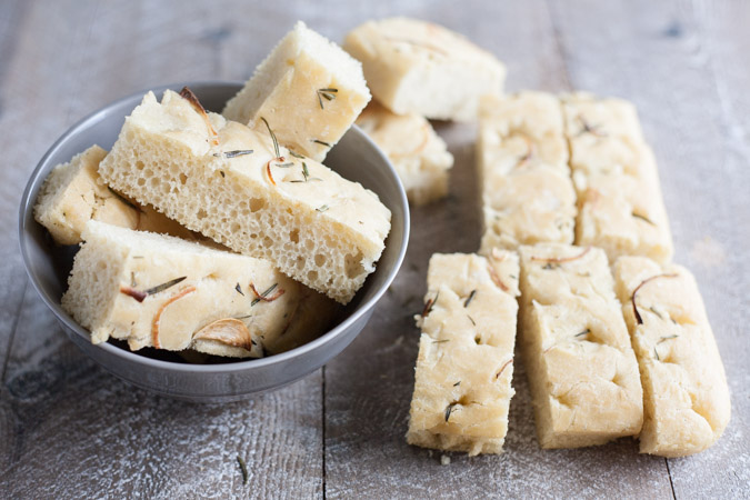 Garlic Rosemary Focaccia Bread | BourbonandHoney.com -- Garlicky, herby and delicious, this Rosemary Focaccia Bread is soft, rich and chewy and perfect for pizza crust, snacking or sandwiches.