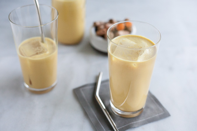 Golden Milk Turmeric Iced Latte | BourbonandHoney.com -- This creamy, cool and slightly sweet Turmeric Iced Latte is a soothing drink made with fresh turmeric, ginger, lemon and almond milk.