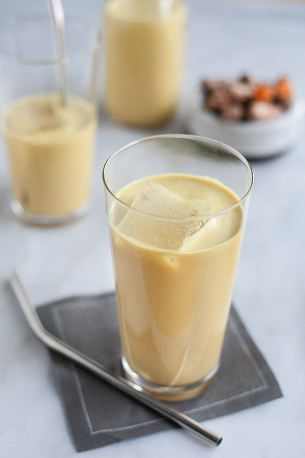 Golden Milk Turmeric Iced Latte | BourbonandHoney.com -- This creamy, cool and slightly sweet Turmeric Iced Latte is a soothing drink made with fresh turmeric, ginger, lemon and almond milk.