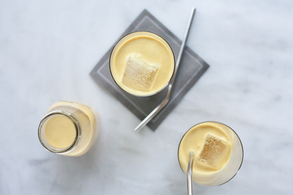 Golden Milk Turmeric Iced Latte | BourbonandHoney.com -- This creamy, cool and slightly sweet Turmeric Iced Latte is a soothing drink made with fresh turmeric, ginger, lemon and almond milk.