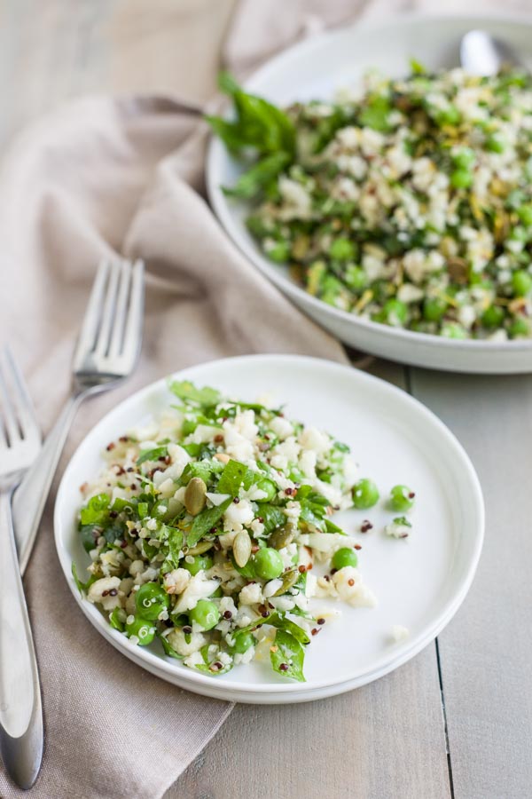 Quinoa Cauliflower Tabbouleh Salad | BourbonandHoney.com -- This Cauliflower Tabbouleh Salad is a fresh spring dish of cauliflower and quinoa paired with herbs, fresh peas, lemon and toasted pepitas.