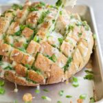 Cheesy Pull-Apart Garlic Bread | BourbonandHoney.com -- This over-the-top Cheesy Pull-Apart Garlic Bread is super cheesy, garlicky and totally delicious! Make it as a side with dinner or as a tasty appetizer.