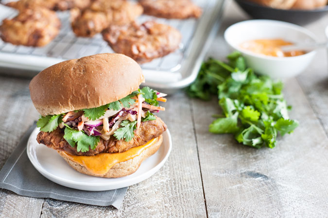 Korean Fried Chicken Sandwich | BourbonandHoney.com -- This Korean Fried Chicken Sandwich is spicy, flavorful and delicious. Topped with a kimchi slaw and gochujang aioli, it's irresistible!