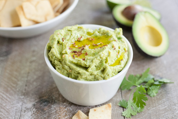 Spicy Avocado Hummus | BourbonandHoney.com -- Rich, creamy and garlicky, this avocado hummus is packed with chickpeas, tahini, a squeeze of lime juice and just the right amount of spice.