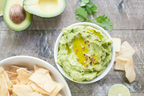 Spicy Avocado Hummus | BourbonandHoney.com -- Rich, creamy and garlicky, this avocado hummus is packed with chickpeas, tahini, a squeeze of lime juice and just the right amount of spice.