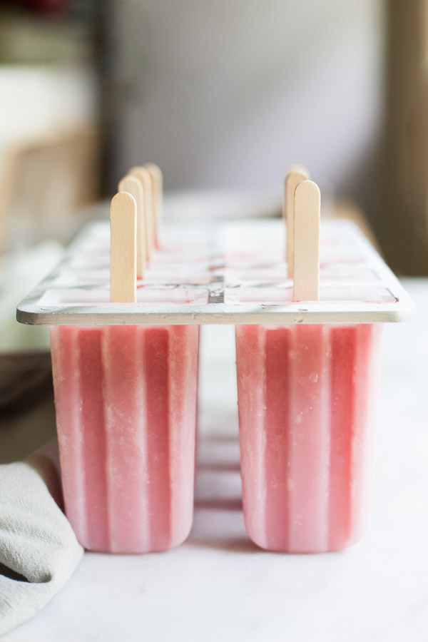 Strawberry Margarita Frozen Pops | BourbonandHoney.com -- These tequila spiked Strawberry Margarita Frozen Pops will be your new go-to summer treat. They're boozy, fruity and perfectly frosty on a hot day! 