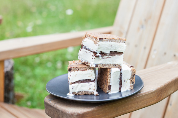 Nutella and Chocolate Chip Cookie Ice Cream Sandwiches | BourbonandHoney.com -- These simple, 3-ingreditent Chocolate Chip Cookie Ice Cream Sandwiches are layered with Nutella and a great way to cool down a crowd with an indulgent summer treat.