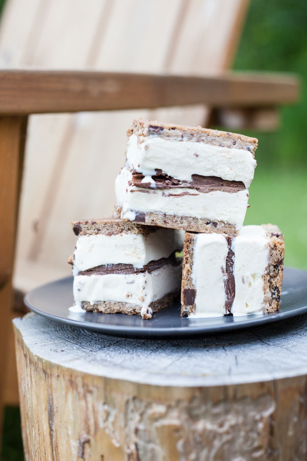 Nutella and Chocolate Chip Cookie Ice Cream Sandwiches | BourbonandHoney.com -- These simple, 3-ingreditent Chocolate Chip Cookie Ice Cream Sandwiches are layered with Nutella and a great way to cool down a crowd with an indulgent summer treat.
