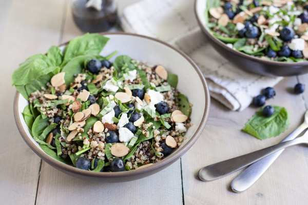 Blueberry, Quinoa and Spinach Salad with Balsamic Vinaigrette | BourbonandHoney.com -- Summery, fresh and delicious this Blueberry, Quinoa and Spinach Salad is simple and packed with colorful berries and crumbled goat cheese.