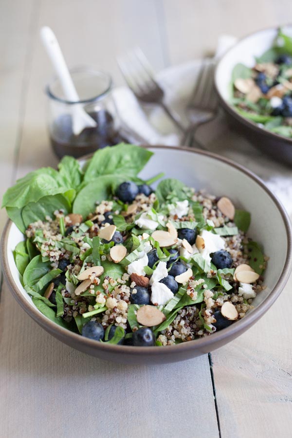 Blueberry, Quinoa and Spinach Salad with Balsamic Vinaigrette | BourbonandHoney.com -- Summery, fresh and delicious this Blueberry, Quinoa and Spinach Salad is simple and packed with colorful berries and crumbled goat cheese.