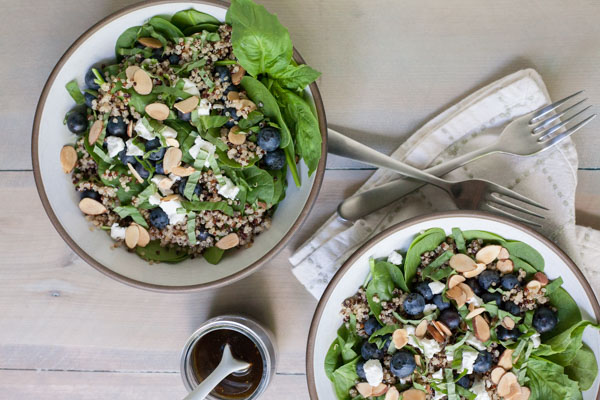 Blueberry, Quinoa and Spinach Salad with Balsamic Vinaigrette | BourbonandHoney.com -- Summery, fresh and delicious this Blueberry, Quinoa and Spinach Salad is simple and packed with colorful berries and crumbled goat cheese.