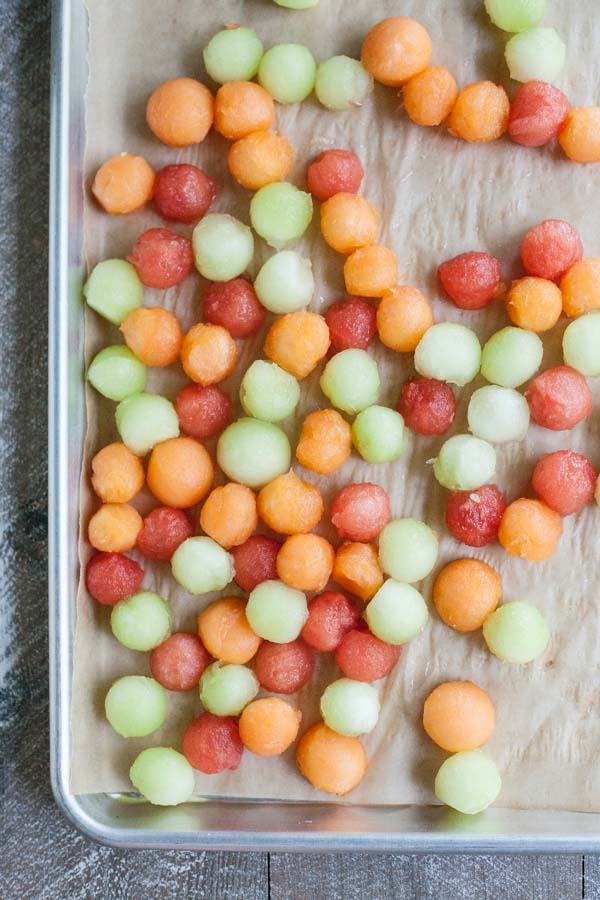 Bourbon and Honey Melon Balls | BourbonandHoney.com -- Boozy, frosty and super refreshing these Bourbon and Honey Melon Balls with fresh mint and lime are the perfect summer happy hour snack.