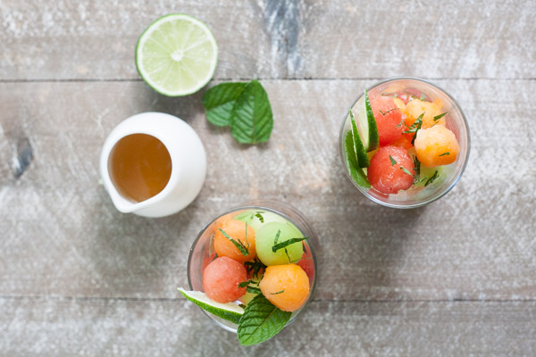 Bourbon and Honey Melon Balls | BourbonandHoney.com -- Boozy, frosty and super refreshing these Bourbon and Honey Melon Balls with fresh mint and lime are the perfect summer happy hour snack.