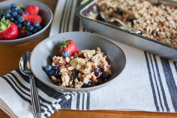 Coconut Baked Oatmeal with Berries | BourbonandHoney.com -- A warm, fruity and hearty Coconut Baked Oatmeal with Berries, almonds and bananas. It's the perfect recipe for a lazy weekend brunch!