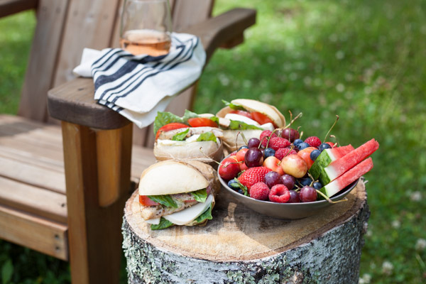 Picnic Perfect Caprese Chicken Sandwich | BourbonandHoney.com -- Seasoned chicken, pesto aioli, summery tomatoes, fresh basil and lots of cheese make these Caprese Chicken Sandwiches quick, delicious and picnic ready!