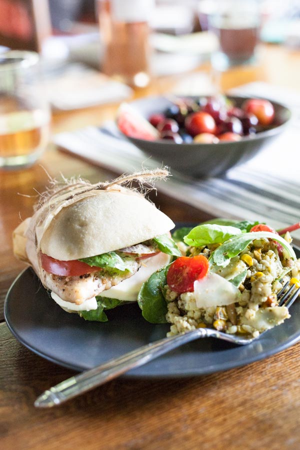 Picnic Perfect Caprese Chicken Sandwich | BourbonandHoney.com -- Seasoned chicken, pesto aioli, summery tomatoes, fresh basil and lots of cheese make these Caprese Chicken Sandwiches quick, delicious and picnic ready!