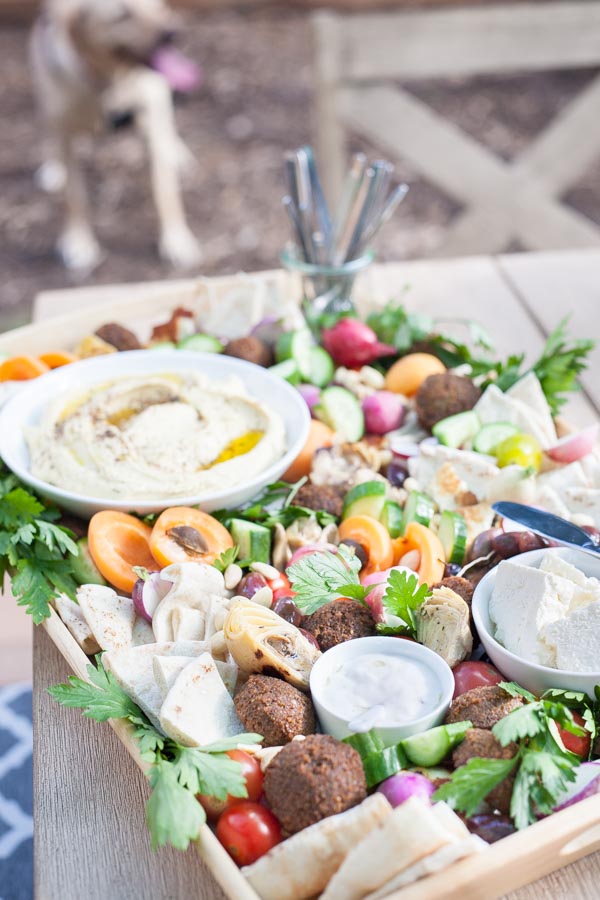Ultimate Mediterranean Hummus Platter | BourbonandHoney.com -- This Mediterranean Hummus platter is the ultimate party appetizer. No need to make anything from scratch, just throw together your favorite ingredients for a seriously simple yet impressive snack.