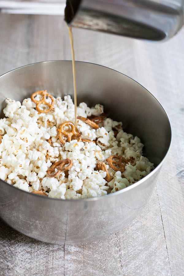 Bourbon and Honey Caramel Corn | BourbonandHoney.com -- Salty pretzels and crunchy nuts make this Bourbon and Honey Caramel Corn perfectly sweet and salty for a delicious food gift of tasty snack!