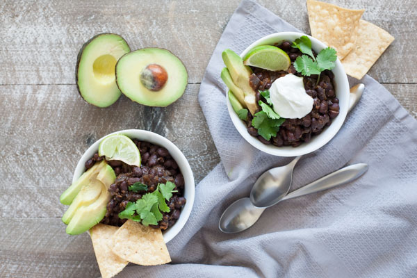 Spicy Slow Cooker Black Beans | BourbonandHoney.com -- This Spicy Slow Cooker Black Bean recipe is quick, flavorful and super easy to customize. Serve it with rice, tortilla chips and all your favorite toppers.