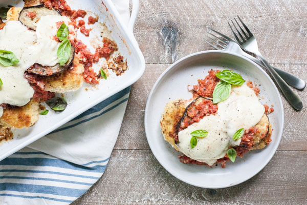Eggplant Chicken Parmesan | BourbonandHoney.com -- Cheesy, delicious and in the oven in just 30 minutes, this Eggplant Chicken Parmesan dish is the best way to enjoy two of your favorite recipes.