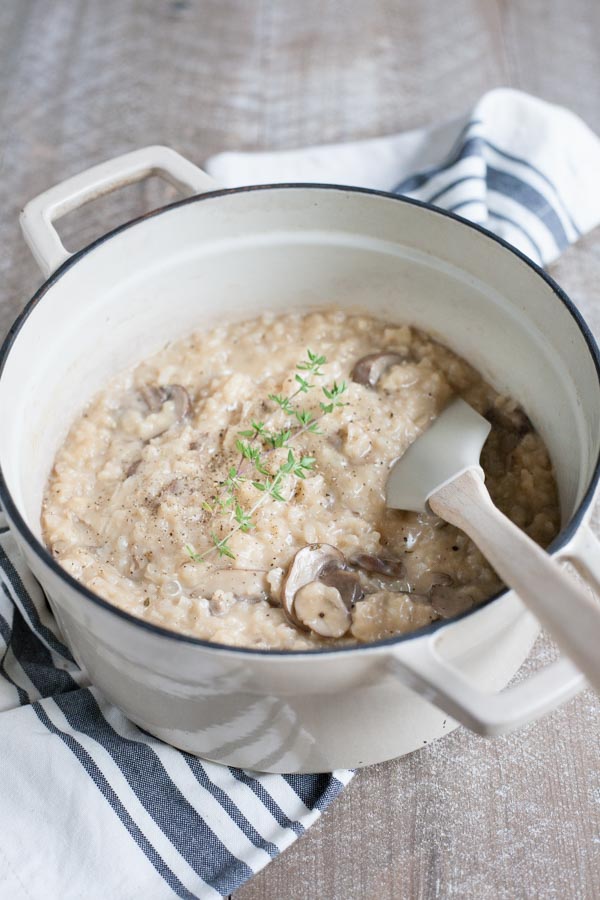 Easy Oven Risotto with Mushrooms | BourbonandHoney.com -- Creamy, cheesy and oh-so comforting, this Easy Oven Risotto with mushrooms is so quick to make that you can even serve it during the week!