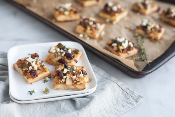 Caramelized Onion Apple Tarts with Blue Cheese and Cranberries | BourbonandHoney.com -- These super flavorful Caramelized Onion and Apple Tarts with Blue Cheese and Cranberries are the perfect bite sized appetizer!