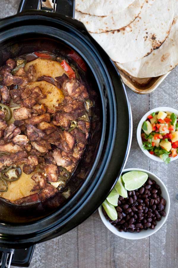 Slow Cooker Jamaican Jerk Chicken Tacos | BourbonandHoney.com -- Spicy, sweet and super flavorful, these Slow Cooker Jamaican Jerk Chicken Tacos are an easy make ahead dinner that can serve a crowd!