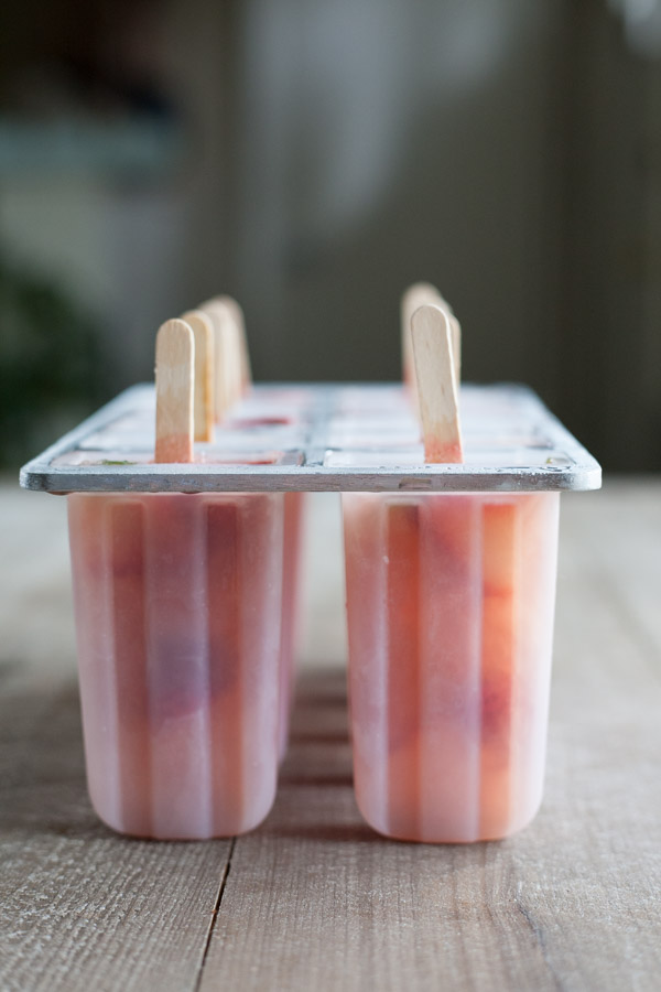Bourbon and Honey Strawberry Mint Julep Popsicles | BourbonandHoney.com Square -- Frozen, boozy and super summery, these Bourbon and Honey spiked Strawberry Mint Julep Popsicles are going to be a keeper!