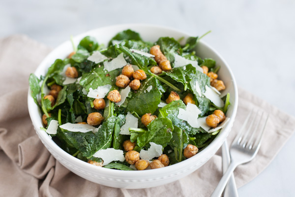 Baby Kale Salad with Crispy Parmesan Chickpeas | BourbonandHoney.com -- Simple, flavorful and impossibly easy, this Baby Kale Salad with Crispy Parmesan Chickpeas recipe is my go-to for both weeknight meals and dinner parties.