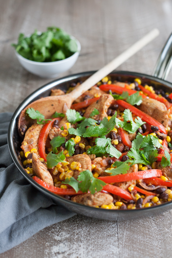 Easy Skillet Chicken with Black Beans and Corn | BourbonandHoney.com -- Spicy, delicious and on the table in 20 minutes, this Easy Skillet Chicken recipe is a serious weeknight winner and a quick family favorite!