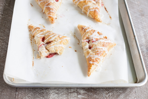 Easy Strawberry Rhubarb Turnovers | BourbonandHoney.com -- Sweet, tarty and perfectly flaky these Strawberry Rhubarb Turnovers are a deliciously easy spring treat or brunch recipe!