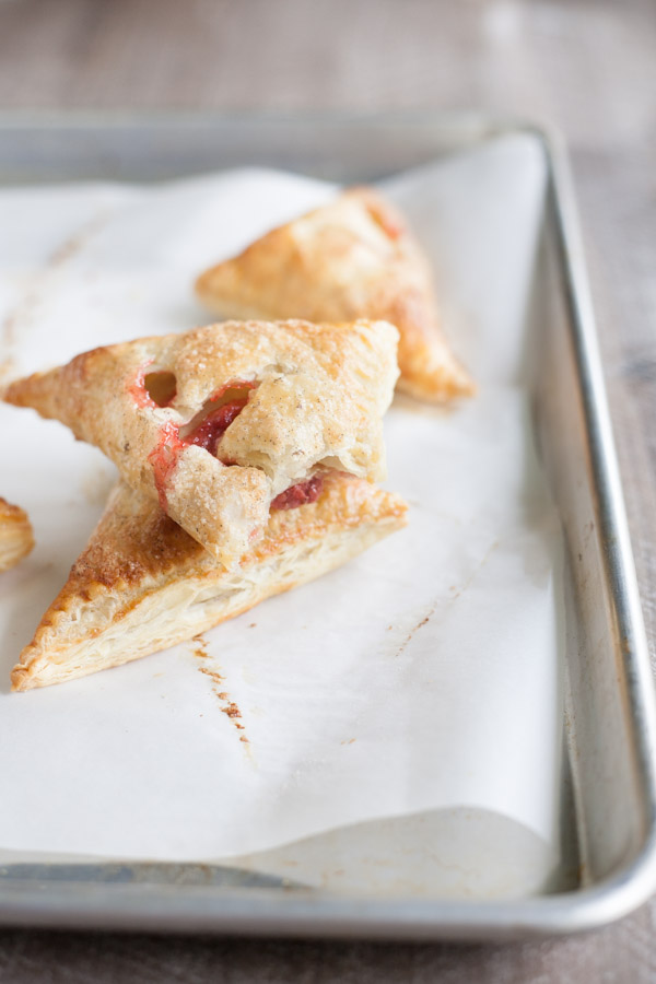 Easy Strawberry Rhubarb Turnovers | BourbonandHoney.com -- Sweet, tart and perfectly flaky these Strawberry Rhubarb Turnovers are a deliciously easy spring treat or brunch recipe!