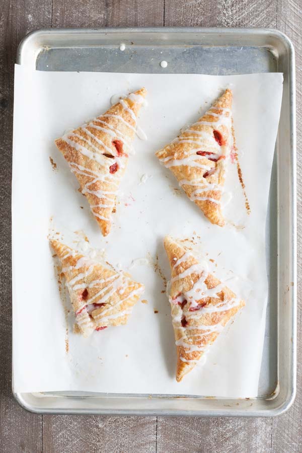 Easy Strawberry Rhubarb Turnovers | BourbonandHoney.com -- Sweet, tart and perfectly flaky these Strawberry Rhubarb Turnovers are a deliciously easy spring treat or brunch recipe!
