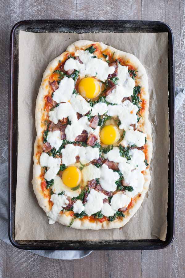 Bacon and Egg Burrata Breakfast Pizza | BourbonandHoney.com -- Start your morning right with this Bacon and Egg Burrata Breakfast Pizza recipe. It's cheesy, bacon-y and top with perfectly cooked eggs.