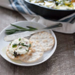 Baked Goat Cheese with Garlic and Herbs | BourbonandHoney.com -- This Baked Goat Cheese with Garlic and Herbs recipe is a quick and flavorful appetizer for a crowd. Besides being super easy, you can also make it ahead of time so you can really enjoy the party!